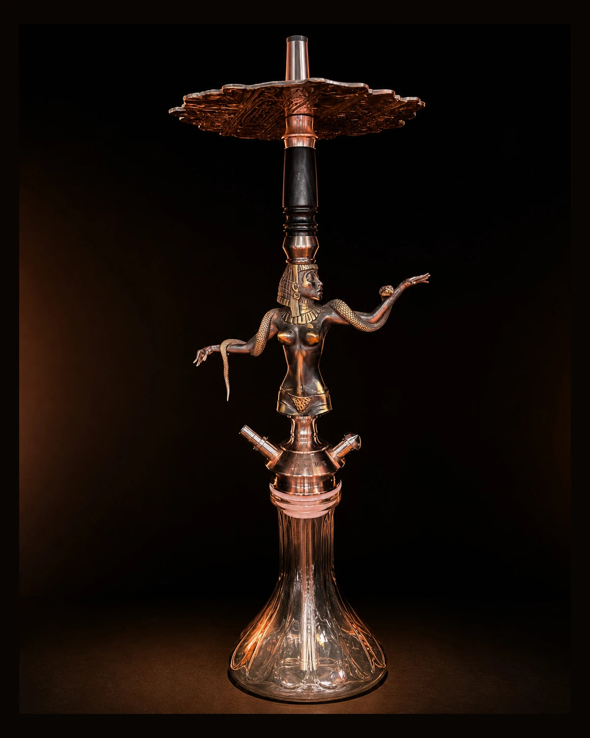 Sculptural hookah hardware photographed in a dark studio